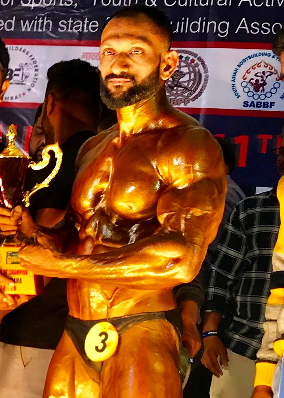 Santosh Salekar on competition stage with trophy